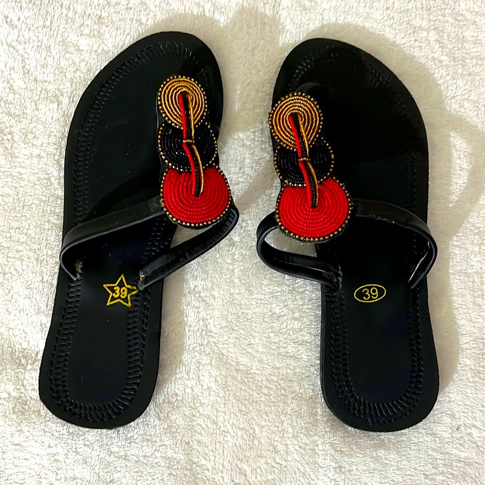 Black slippers with red and golden accents that works with any outfit